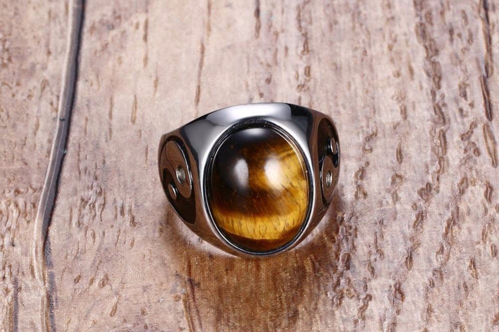 top view of a Silver ring with a tiger's eye stone on a wooden surface