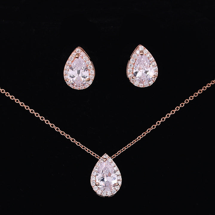 Jewelry set with teardrop-shaped earrings and necklace on a black background