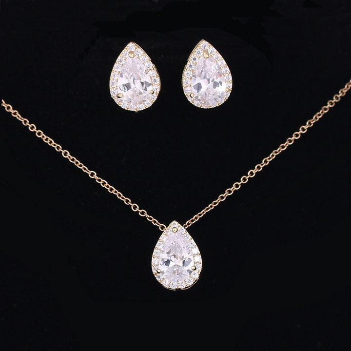 Jewelry set with teardrop-shaped crystal necklace and earrings on a black background