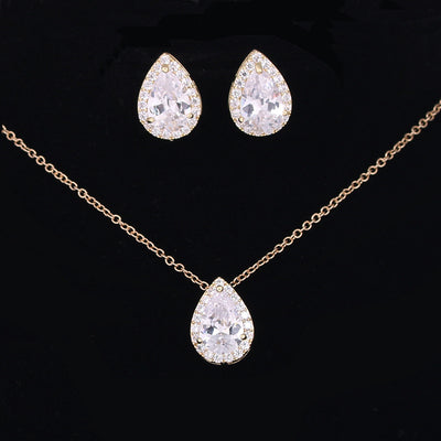 Jewelry set with teardrop-shaped crystal necklace and earrings on a black background