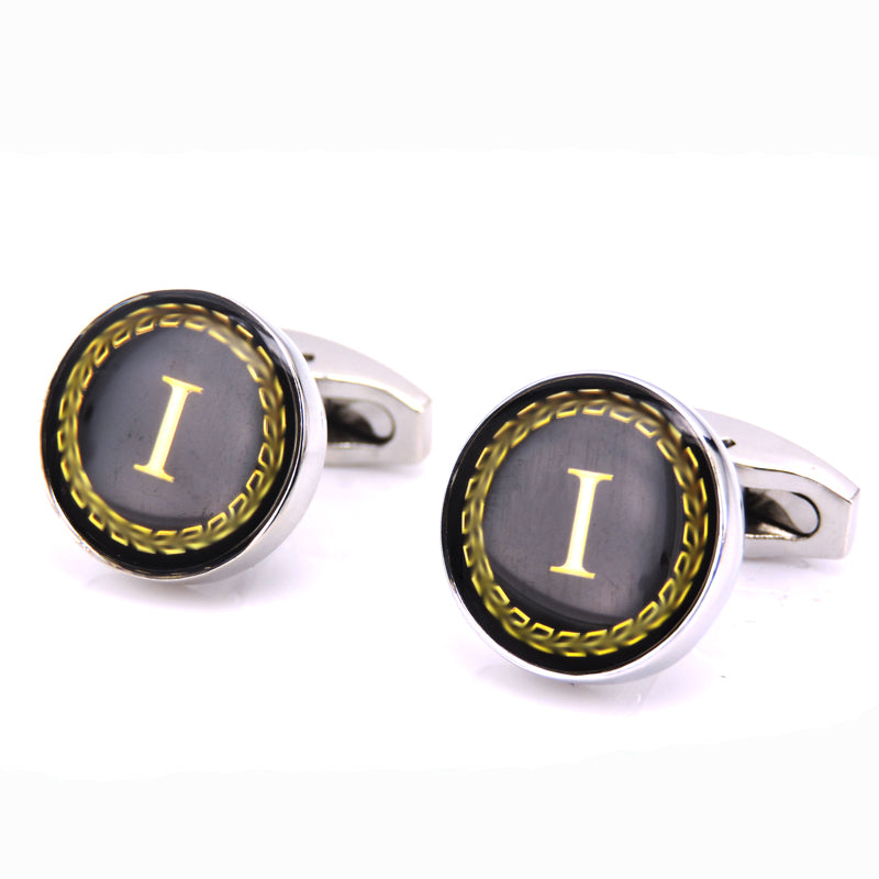 Pair of cufflinks with black background and gold letter &