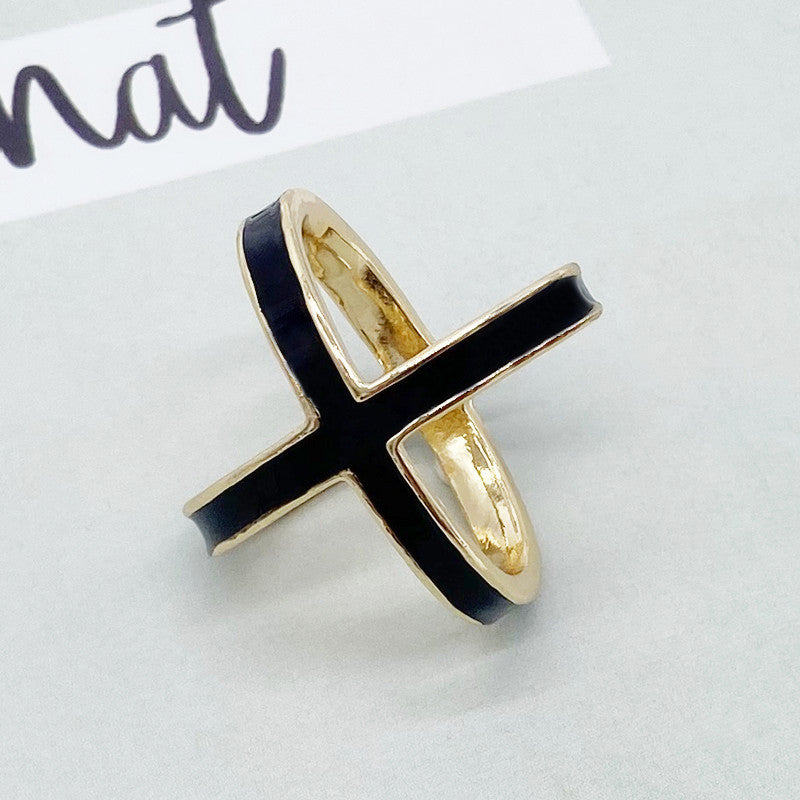 Gold ring with black band on a white background
