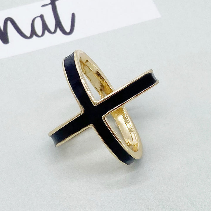 Gold ring with black band on a white background