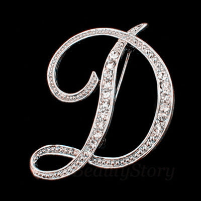 Silver brooch with letter &
