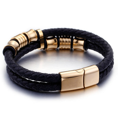 Black leather bracelet with gold metal accents on a white background