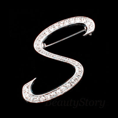Silver brooch with rhinestones shaped like the letter &