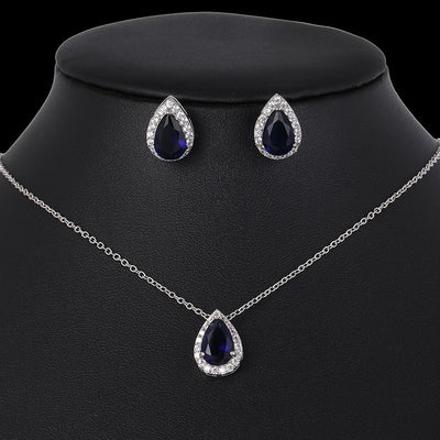 Teardrop-shaped jewelry set with necklace and earrings on a black mannequin bust.
