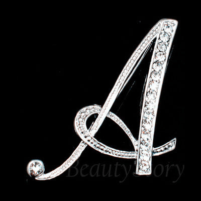 Silver brooch with letter &