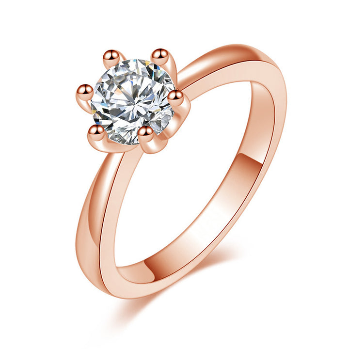 Rose gold ring with a large diamond on a white background
