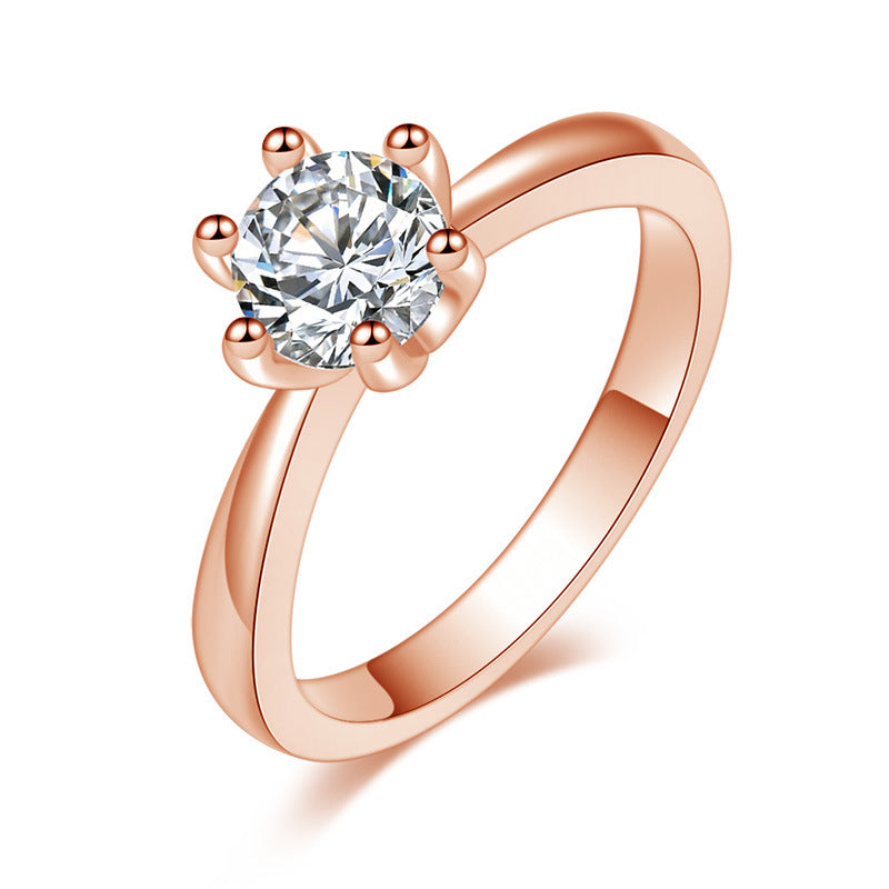 Rose gold ring with a large diamond on a white background