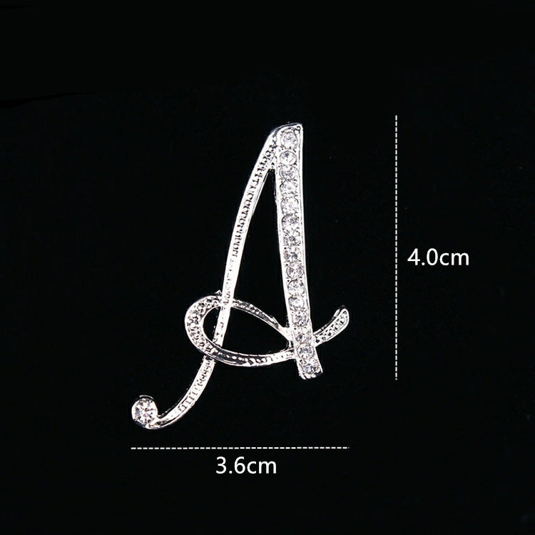 Silver brooch shaped like the letter &