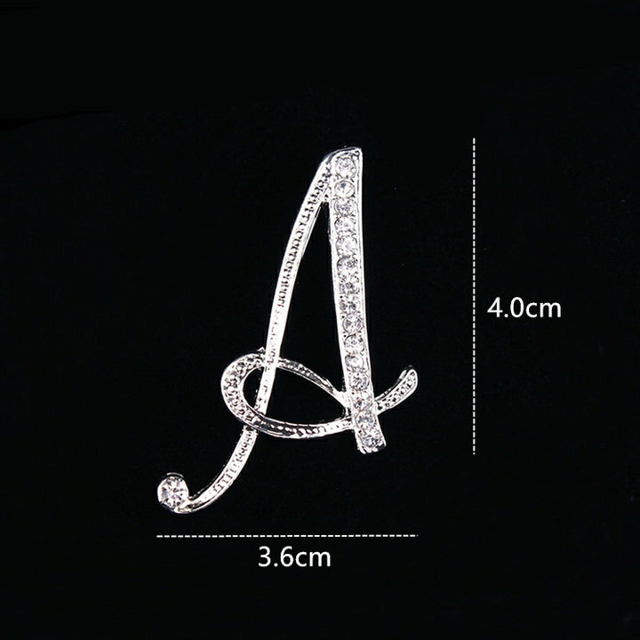 Silver brooch shaped like the letter &