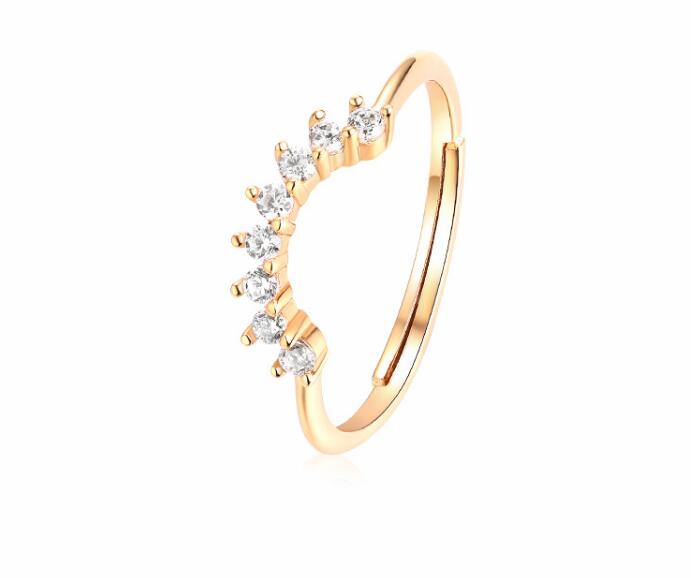 Gold ring with diamond accents on a white background