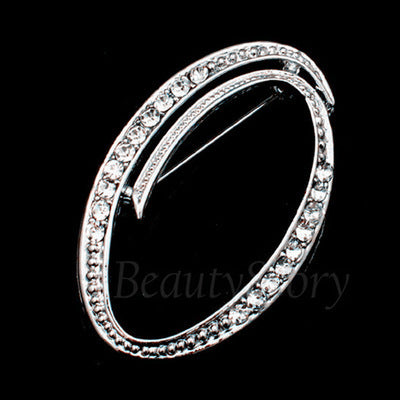 Silver ring with clear stones of letter O on a black background, branded &