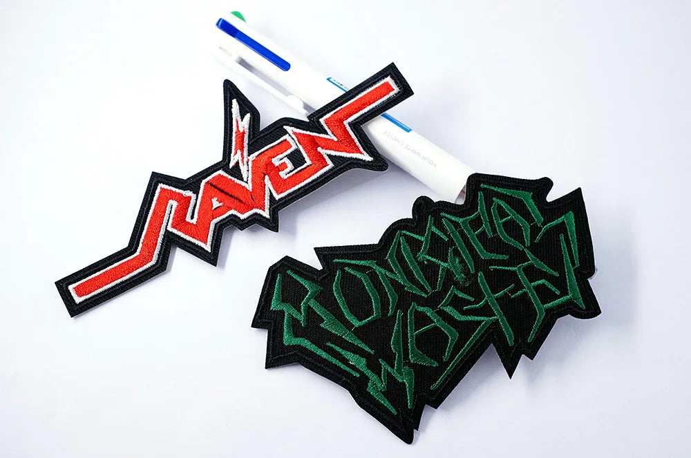 Two embroidered patches with 'Slayer' and 'Omnium Gatherum' logos on a white background.