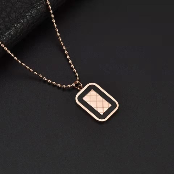 Necklace with a square pendant on a dark background