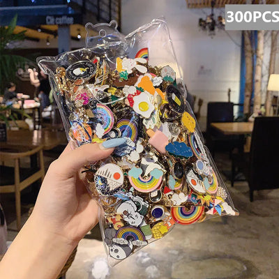 Clear plastic bag filled with colorful pins held by a hand in an indoor setting.
