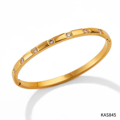 Gold bracelet with small diamonds on a white background