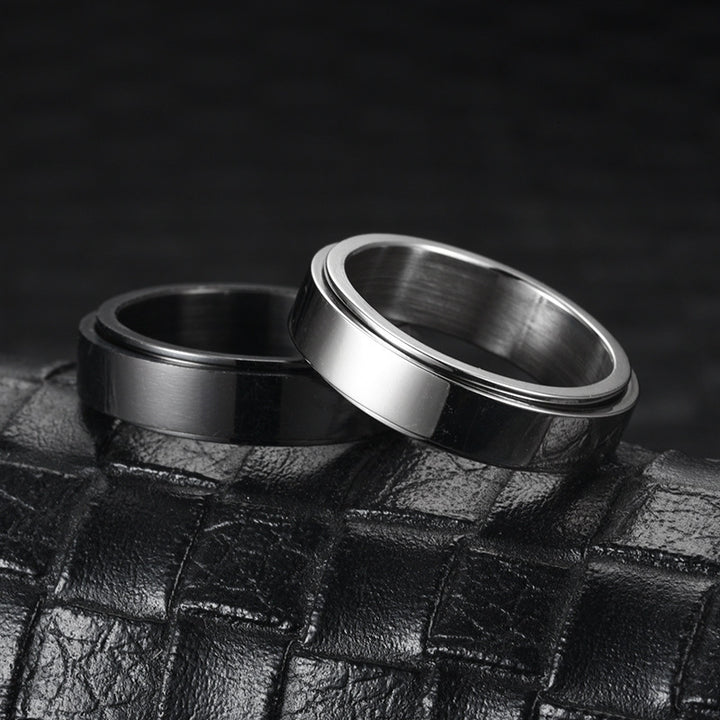 Two metallic rings on a textured black surface