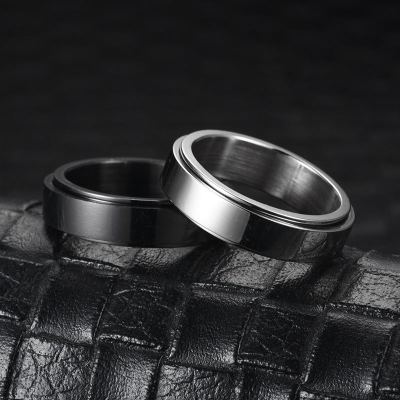 Two metallic rings on a textured black surface