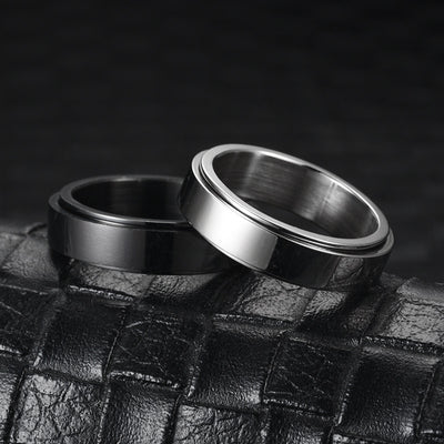 Two metallic rings on a textured black surface