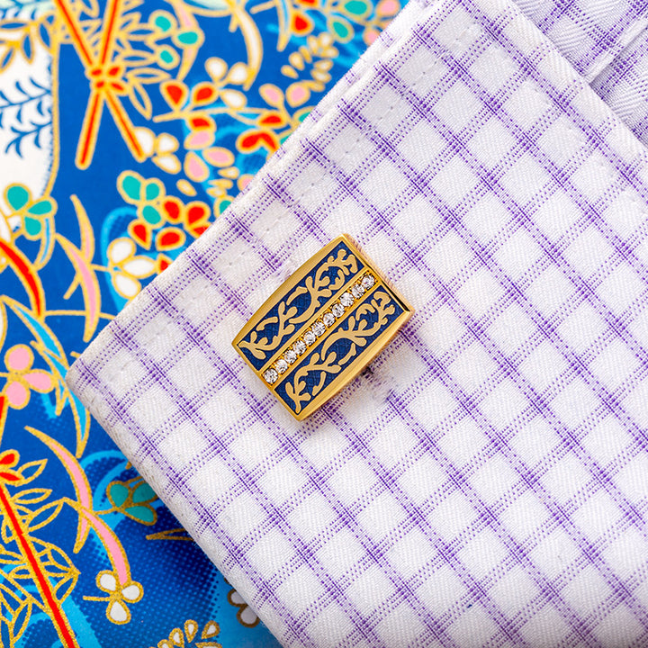 Gold and blue cufflinks on a checkered shirt 
