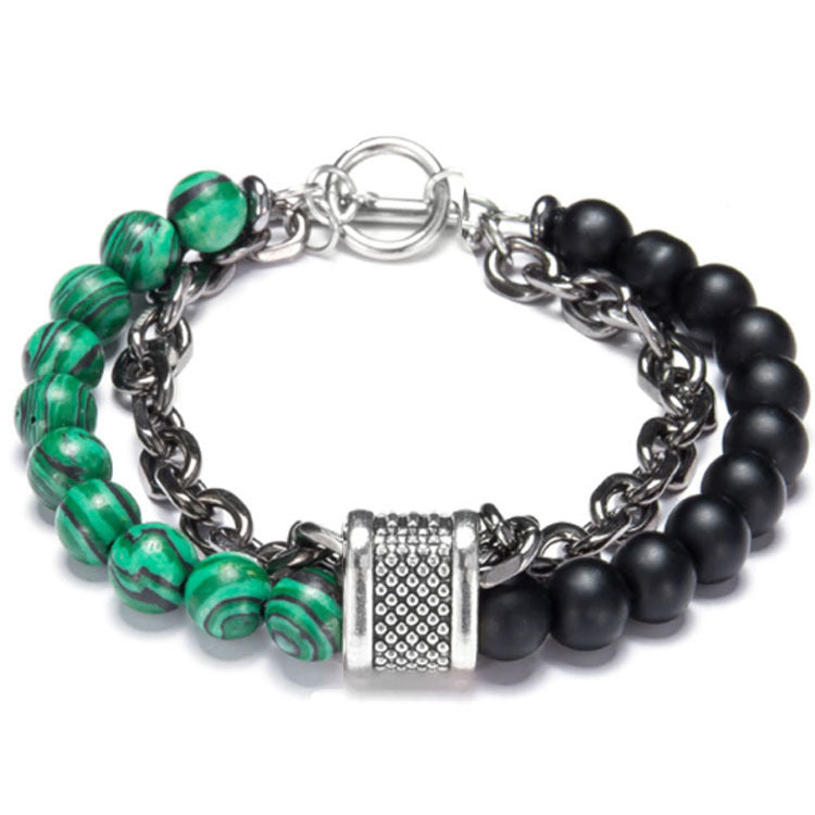 Bracelet with green and black beads and a silver clasp on a white background