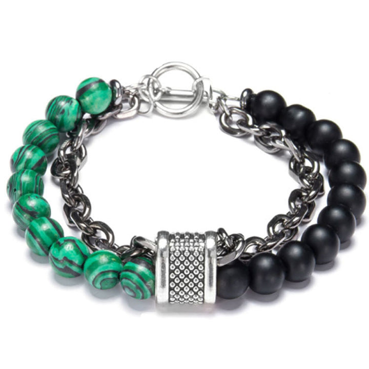 Bracelet with green and black beads and a silver clasp on a white background
