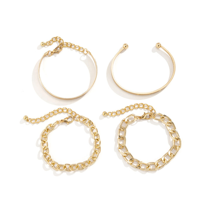 Set of gold bracelets on a white background