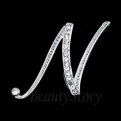 Silver brooch shaped like the letter &