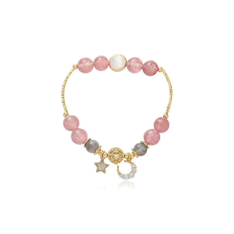 Bracelet with pink and gray beads and gold charms on a white background