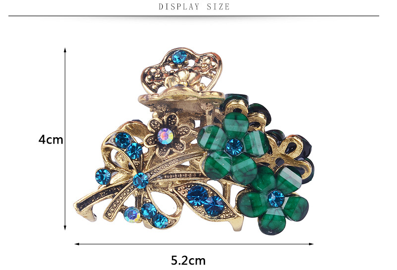 Decorative hair clip with green gemstones and gold accents, displayed with measurements on a white background.
