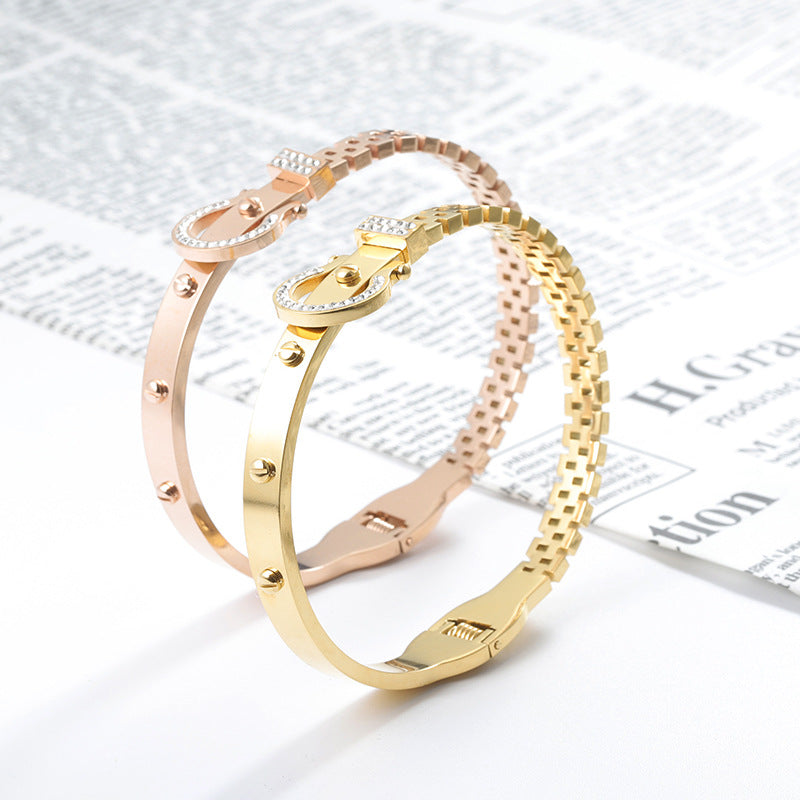 Gold and rose gold bangles on a newspaper background