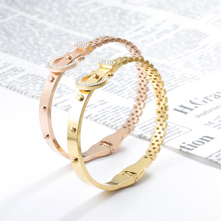 Gold and rose gold bangles on a newspaper background