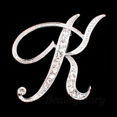 Silver brooch with the letter &