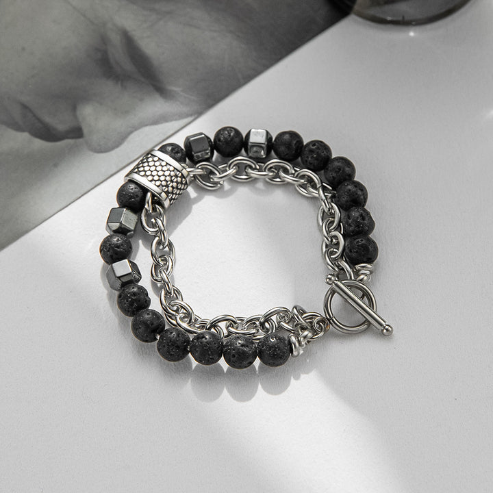 Bracelet with black beads and silver chain on a white surface