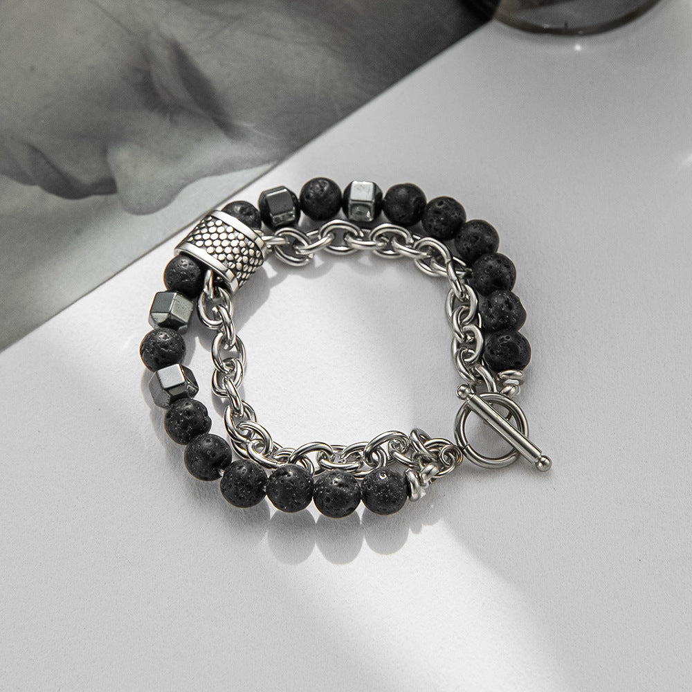 Bracelet with black beads and silver chain on a white surface