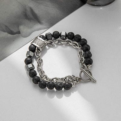 Bracelet with black beads and silver chain on a white surface