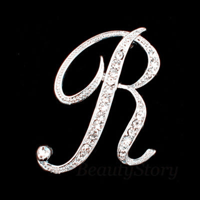 Silver brooch with letter &