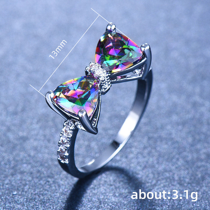 Ring with colorful gemstones and measurements on a gray background