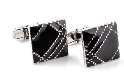 Black square cufflinks with silver accents on a white background