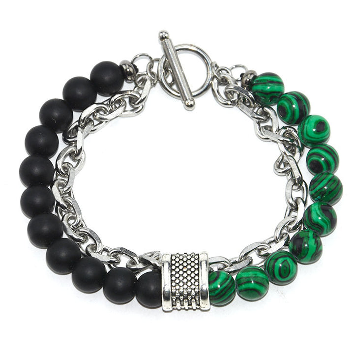 Bracelet with black beads and green marbled stones on a white background