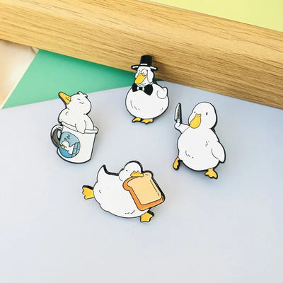 Set of cartoon duck pins on a flat surface