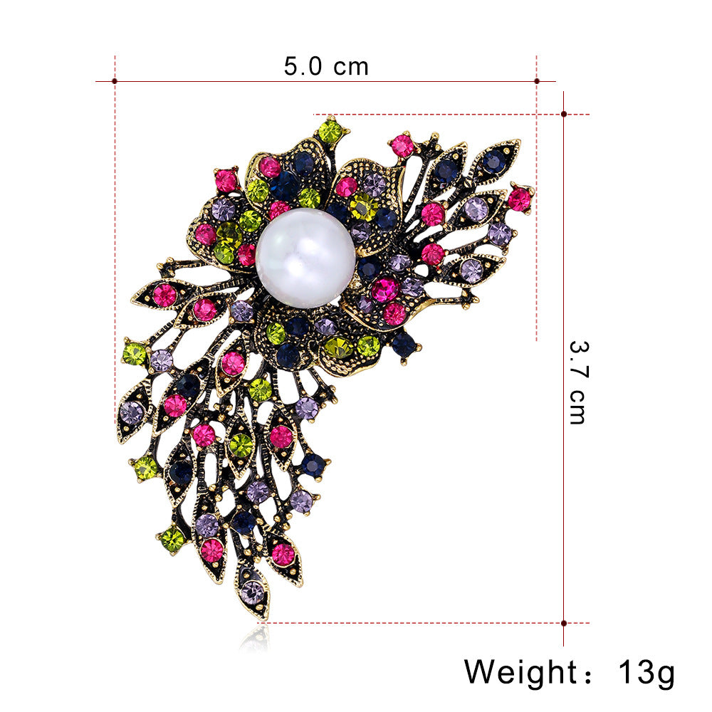Decorative brooch with gemstones and pearl, shown with measurements on a white background