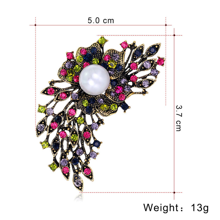 Decorative brooch with gemstones and pearl, shown with measurements on a white background