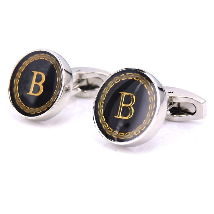 Cufflinks with black and gold design and letter &