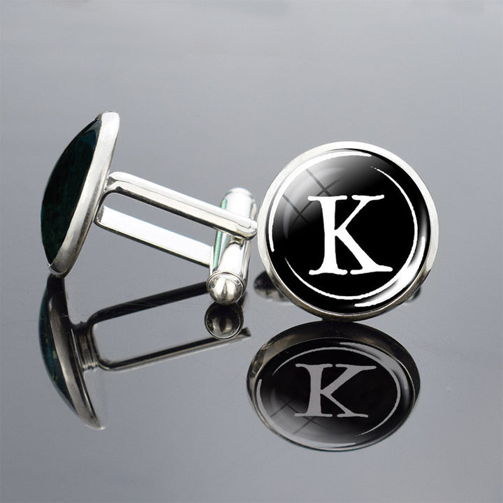 Cufflinks with a black background and white letter &