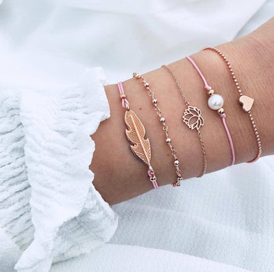 Bracelets with feather and leaf designs on a white background