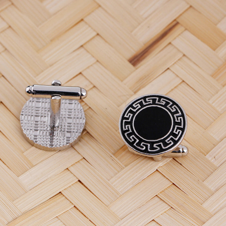 Two cufflinks on a woven wooden surface