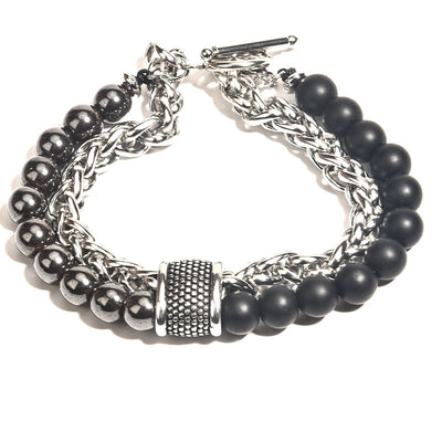 Bracelet with black beads and silver chain on a white background